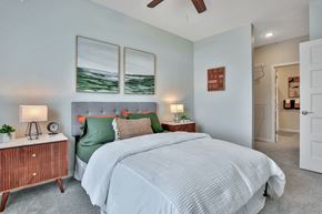 Maple Grove apartment for rent - A bedroom with a large bed and a wooden nightstand.