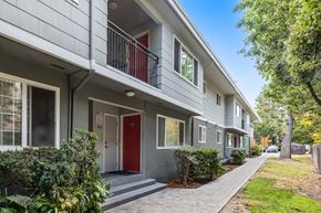 Fremont apartment for rent - a grey apartment building with a red door