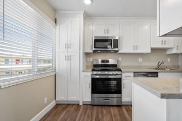 Castro Valley apartment for rent - A kitchen with white cabinets and a stainless steel oven.