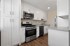Castro Valley apartment for rent - A kitchen with white cabinets and stainless steel appliances.