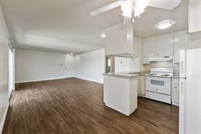 San Leandro apartment for rent - A kitchen with white appliances and wooden floors.