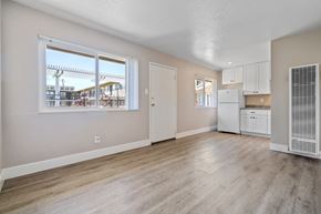 Livermore apartment for rent - A spacious room with a kitchen area and a window overlooking a building.