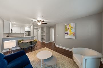 San Leandro apartment for rent - A living room with a blue chair and a painting on the wall.