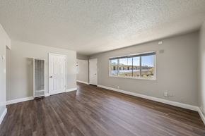 Alameda apartment for rent - A room with wooden floors and a large window.
