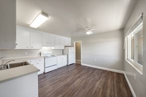 Alameda apartment for rent - A kitchen with white cabinets and a wooden floor.