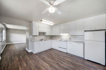 Alameda apartment for rent - A kitchen with white cabinets and a wooden floor.