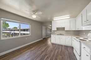 Alameda apartment for rent - A kitchen with white cabinets and a wood floor.