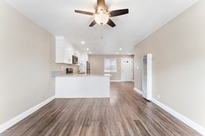 Fremont apartment for rent - A room with a ceiling fan and wooden flooring.