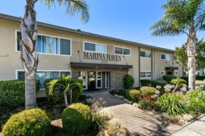 San Leandro apartment for rent - The front of a building named Marina Haven with a clear blue sky in the background.