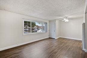 Fremont apartment for rent - a bedroom with hardwood floors and a large window