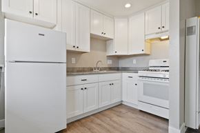 Livermore apartment for rent - A white kitchen with wooden floors and white appliances.