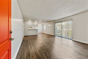 San Leandro apartment for rent - A room with a red door and wooden flooring.