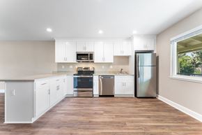 Fremont apartment for rent - A kitchen with white cabinets and a wooden floor.