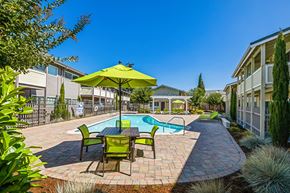 Fremont apartment for rent - swimming pool and sundeck with table, chairs, and umbrella