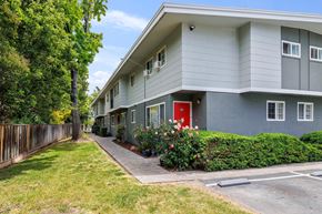 Fremont apartment for rent - a grey apartment building with a red door