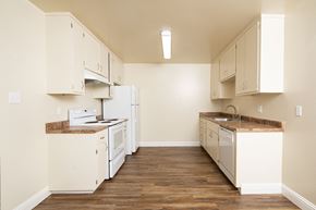 San Leandro apartment for rent - A kitchen with white appliances and cabinets.