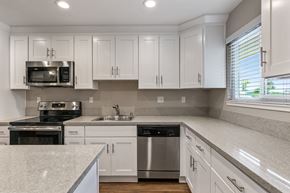 Fremont apartment for rent - A kitchen with white cabinets and stainless steel appliances.