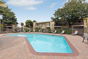 Fremont apartment for rent - A swimming pool surrounded by a brick border and lounge chairs.