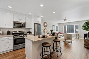 Fremont apartment for rent - A modern kitchen with white cabinets and a large island.