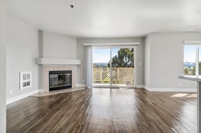 Castro Valley apartment for rent - A spacious living room with a fireplace and sliding glass doors.