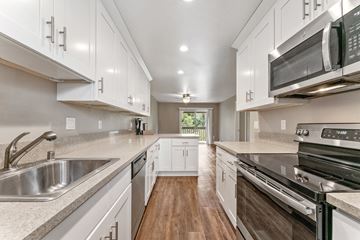 Castro Valley apartment for rent - A modern kitchen with white cabinets and stainless steel appliances.
