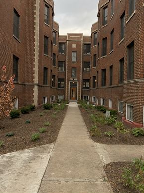 South Bend apartment for rent - an empty walkway between two brick apartment buildings