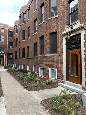 South Bend apartment for rent - a sidewalk in front of a brick apartment building