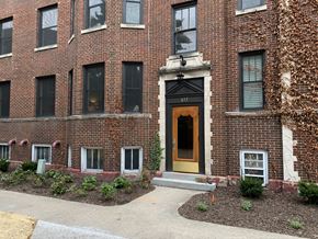 South Bend apartment for rent - the front of a brick building with a yellow door