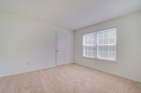 Portsmouth apartment for rent - a spacious bedroom with a large window and carpeting