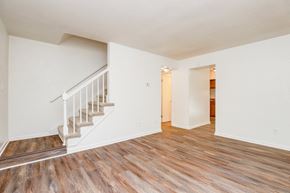 Chesapeake apartment for rent - the living room and dining room of a renovated home with wood flooring and stairs