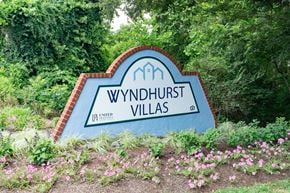 Lynchburg apartment for rent - a sign in front of trees and flowers