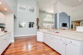 Richmond apartment for rent - a large kitchen with white cabinets and a wood floor