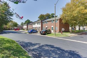 Chesapeake apartment for rent - a city street with brick apartment buildings and cars parked on the curb