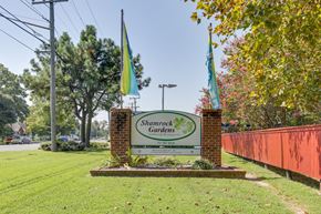 Chesapeake apartment for rent - the sign for shamrock gardens in front of a brick fence