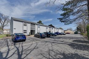 Norfolk apartment for rent - a parking lot with cars in front of a building