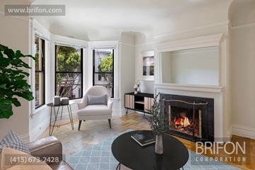 San Francisco apartment for rent - a living room with a fireplace and a table and chairs
