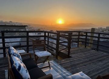 San Francisco apartment for rent - a living room with a view of the sunset over the city