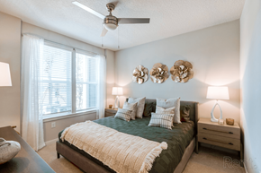 Charlotte apartment for rent - A bedroom with a bed, nightstand, and ceiling fan.