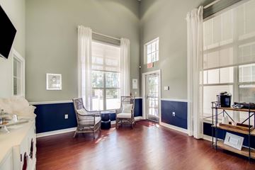 Panama City Beach apartment for rent - A living room with a white sofa and a wooden floor.