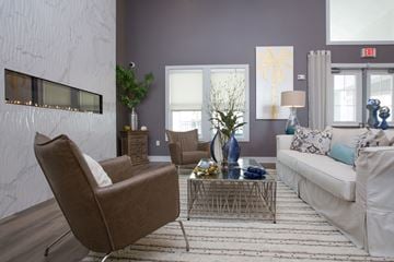 Panama City Beach apartment for rent - A living room with a brown chair and a white couch.