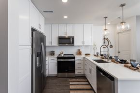 Huntsville apartment for rent - White kitchen with stainless appliances and peninsula counter at 2020 Providence Apartments, Huntsville