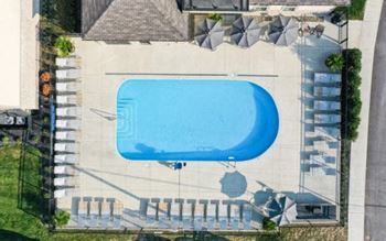 Sparkling swimming pool with sundeck & grill