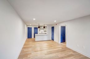 Birmingham apartment for rent - a living room and kitchen with white walls and wood flooring