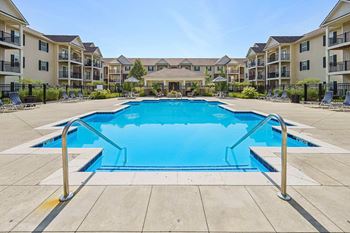 Courtyard oasis swimming pool with expansive sun deck and pavillion