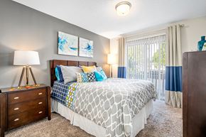 Mobile apartment for rent - spacious primary bedroom with direct access to private patio or balcony at 701 South Apartments in Mobile, AL