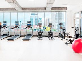Birmingham apartment for rent - a gym with cardio machines and a large window
