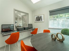 Birmingham apartment for rent - a conference room with a round table and orange chairs