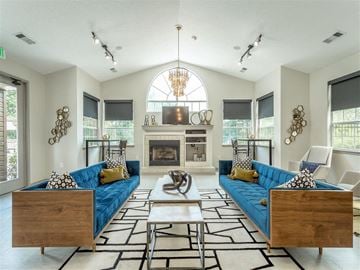 Birmingham apartment for rent - a living room with blue couches and a fireplace