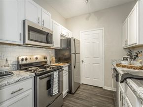Birmingham apartment for rent - a kitchen with stainless steel appliances and white cabinets