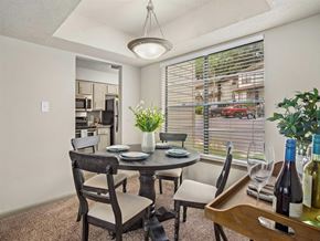 Daphne apartment for rent - a dining room with a table and chairs and a window